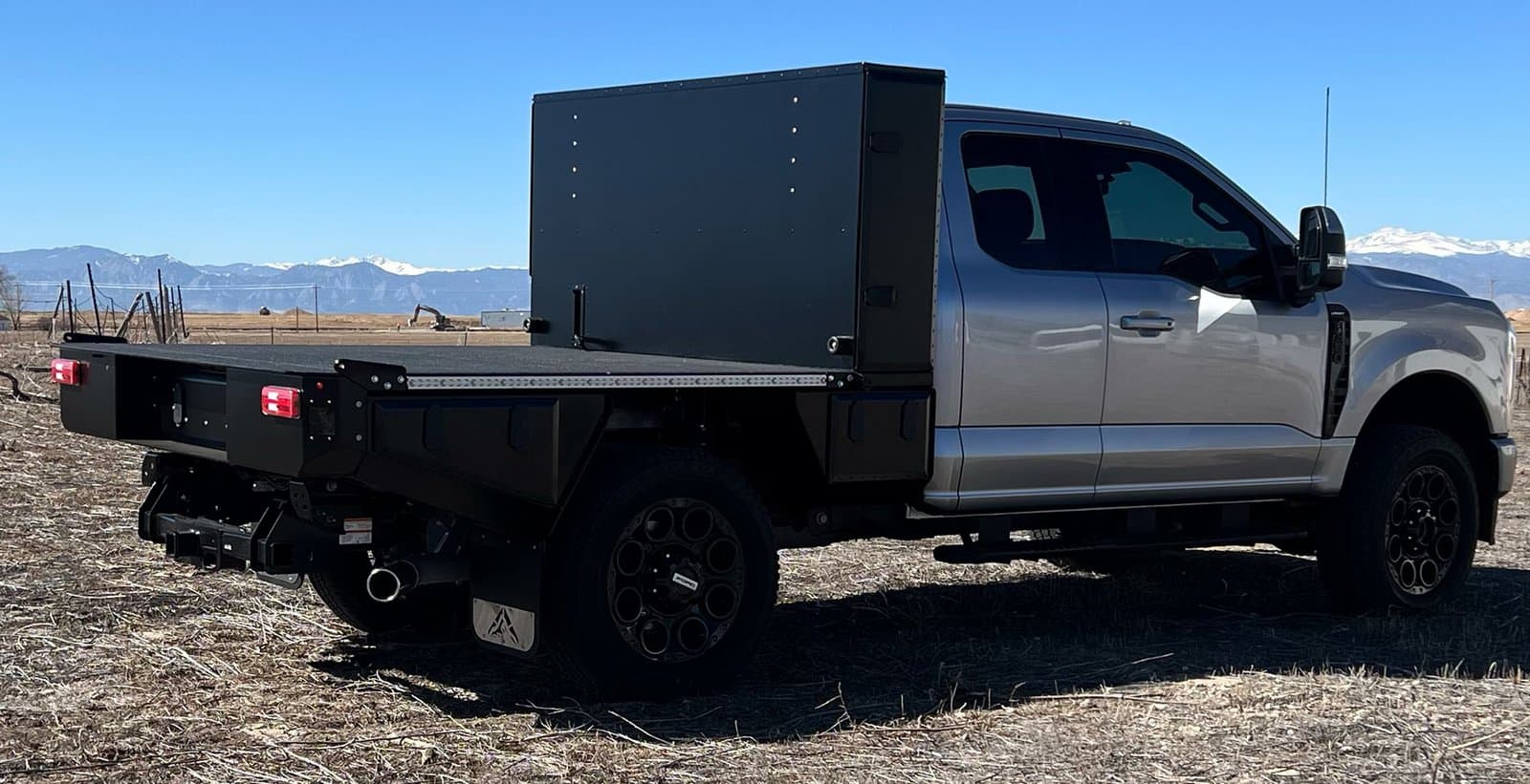 Aluma Tray 6.75 foot aluminum flatbed on a grey pickup with mountains behind
